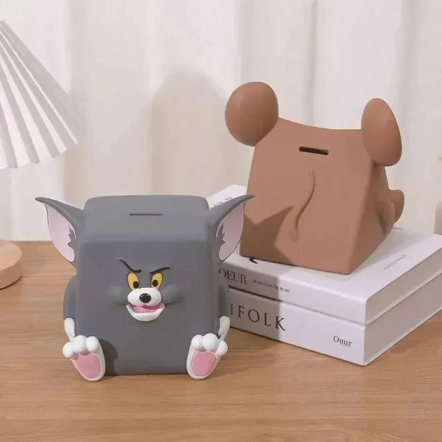 Two cartoon-themed piggy banks on a wooden surface with a neutral background