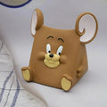 Brown cartoon mouse-shaped object on a white surface
