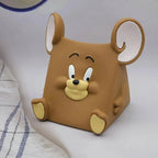 Brown cartoon mouse-shaped object on a white surface