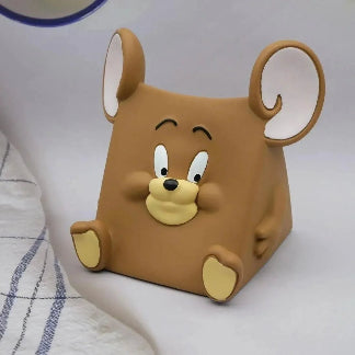 Brown cartoon mouse-shaped object on a white surface
