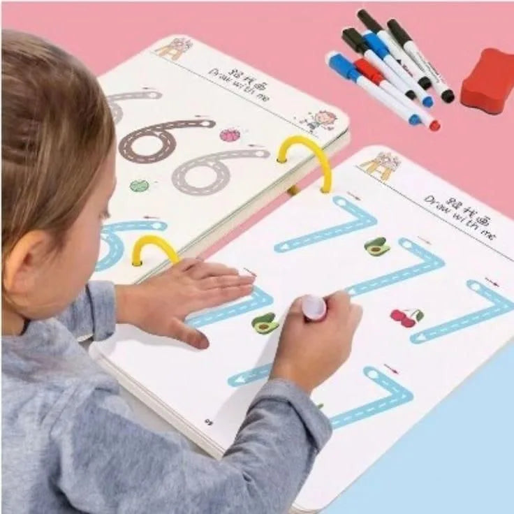 Child using a educational toy with number tracing boards and markers on a pink and blue background.