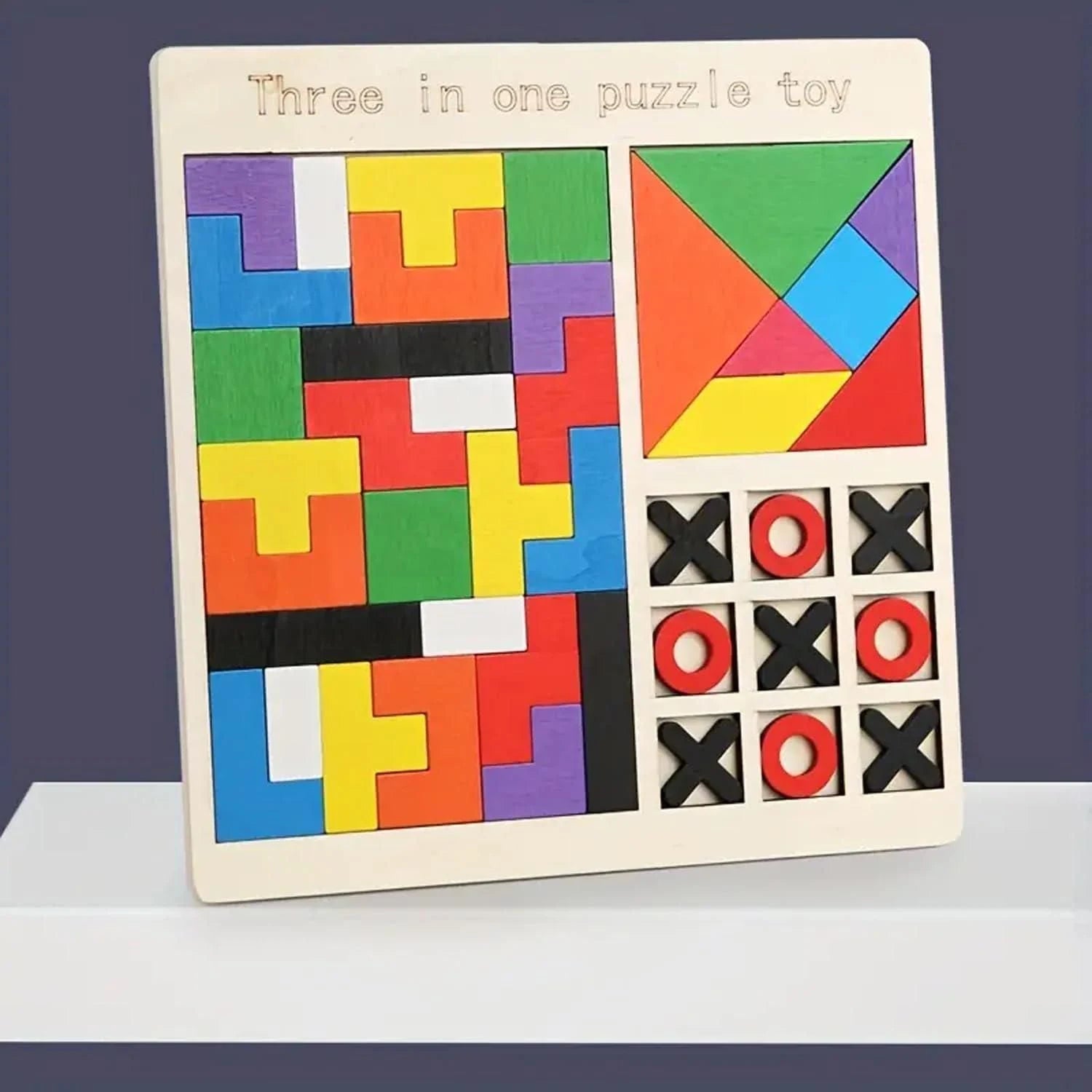 Three-in-one puzzle toy with colorful geometric shapes and tic-tac-toe grid on a white surface.