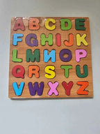 Wooden alphabet puzzle with colorful letters on a gray background