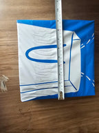Blue and white fabric with a ruler for scale on a wooden surface