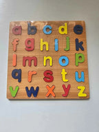 Wooden alphabet puzzle with colorful letters on a plain background