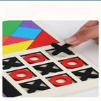 Colorful geometric shapes on a board with a hand placing an 'X' piece.
